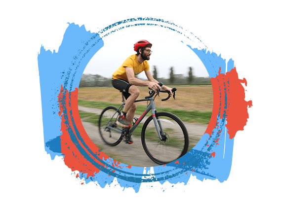 Man Biking on a Trail Wearing a Red Helmet