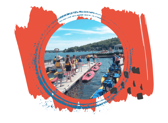 Group standing on dock surrounded by pedalboards and hydrobikes