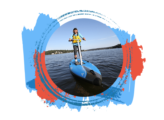 Women happily operating her paddleboard on Lake Hopatcong